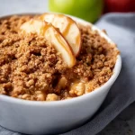 Delicious high protein apple crisp dessert served in a bowl.