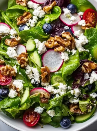 Colorful spring Easter salad topped with creamy goat cheese and fresh vegetables
