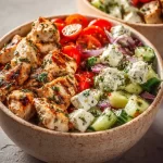 Healthy Greek chicken bowls served with creamy tzatziki sauce