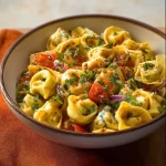 Hot honey tortellini pasta salad with vibrant ingredients in a bowl.