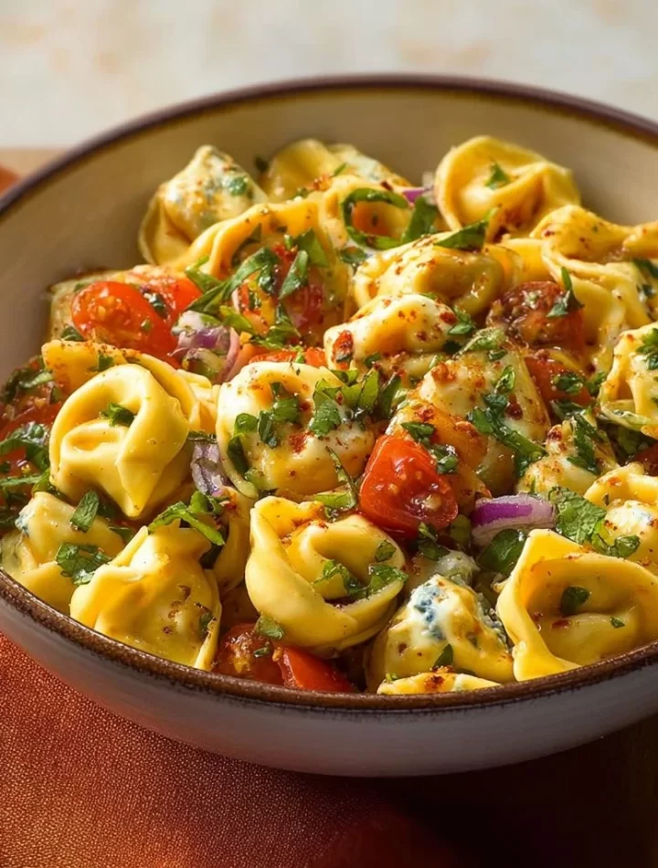 Hot honey tortellini pasta salad with vibrant ingredients in a bowl.