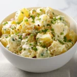Delicious homemade potato salad recipe with vegetables and dressing
