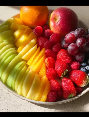 Vibrant rainbow fruit platter featuring a variety of colorful fruits arranged beautifully.