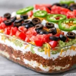 American Flag Layered Taco Dip with colorful layers for festive gatherings.