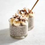 Delicious bowl of Banana Chia Pudding topped with banana slices and nuts