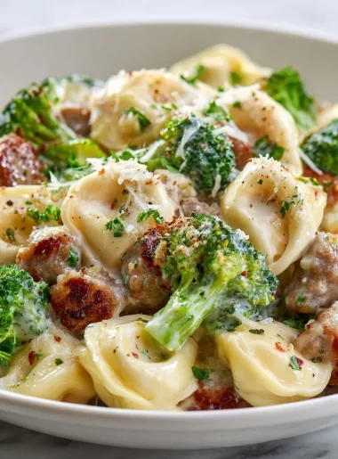 Creamy Garlic Parmesan Tortellini with sausage and broccoli served in a bowl