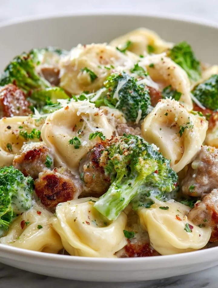 Creamy Garlic Parmesan Tortellini with sausage and broccoli served in a bowl