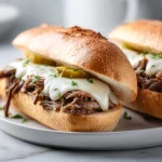 Crockpot French Dip Sandwiches served with au jus for dipping.