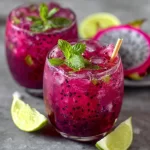 Refreshing Dragon Fruit Juice Mojito served in a glass, garnished with mint and lime.