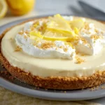 Slice of easy lemon cream pie with lemon garnish on a plate