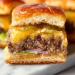 Hawaiian Roll Cheeseburger Sliders served on a plate with toppings.