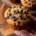 Freshly baked healthy peanut butter banana muffins on a wooden table