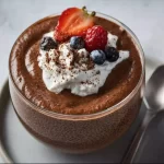 High protein chocolate chia seed pudding in a bowl with chocolate toppings
