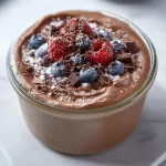 Delicious homemade protein pudding topped with fruit and nuts