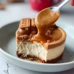 Delicious slice of Lotus Biscoff Cheesecake topped with crumbs and sauce.