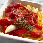 Pasta topped with roasted pepper and tomato sauce for a vibrant flavor.
