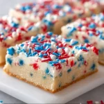 Patriotic Sugar Cookie Bars decorated with red, white, and blue sprinkles
