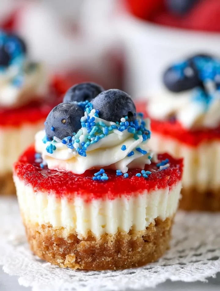 Red, white, and blue mini cheesecakes topped with berries for a patriotic dessert