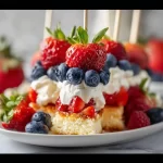 Red, White & Blue Berry Shortcake Skewers with strawberries, blueberries, and cake on a stick