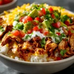 Savory Slow Cooker Chicken Burrito Bowl with rice, beans, and fresh toppings