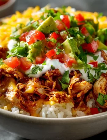 Savory Slow Cooker Chicken Burrito Bowl with rice, beans, and fresh toppings