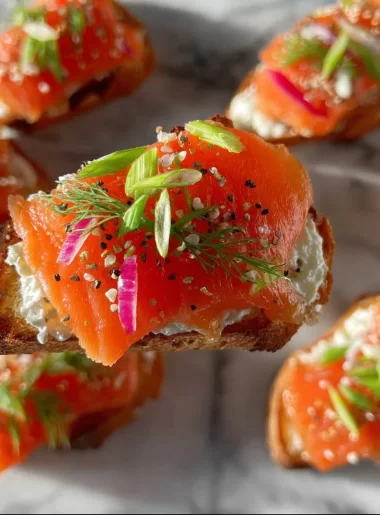 Delicious smoked salmon crostini garnished with herbs and served on a platter