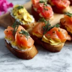 Delicious smoked salmon crostini topped with herbs on a platter