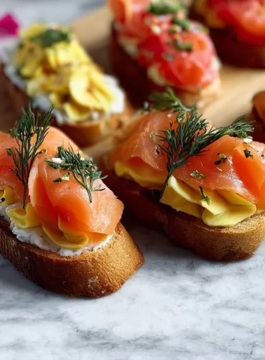 Delicious smoked salmon crostini topped with herbs on a platter