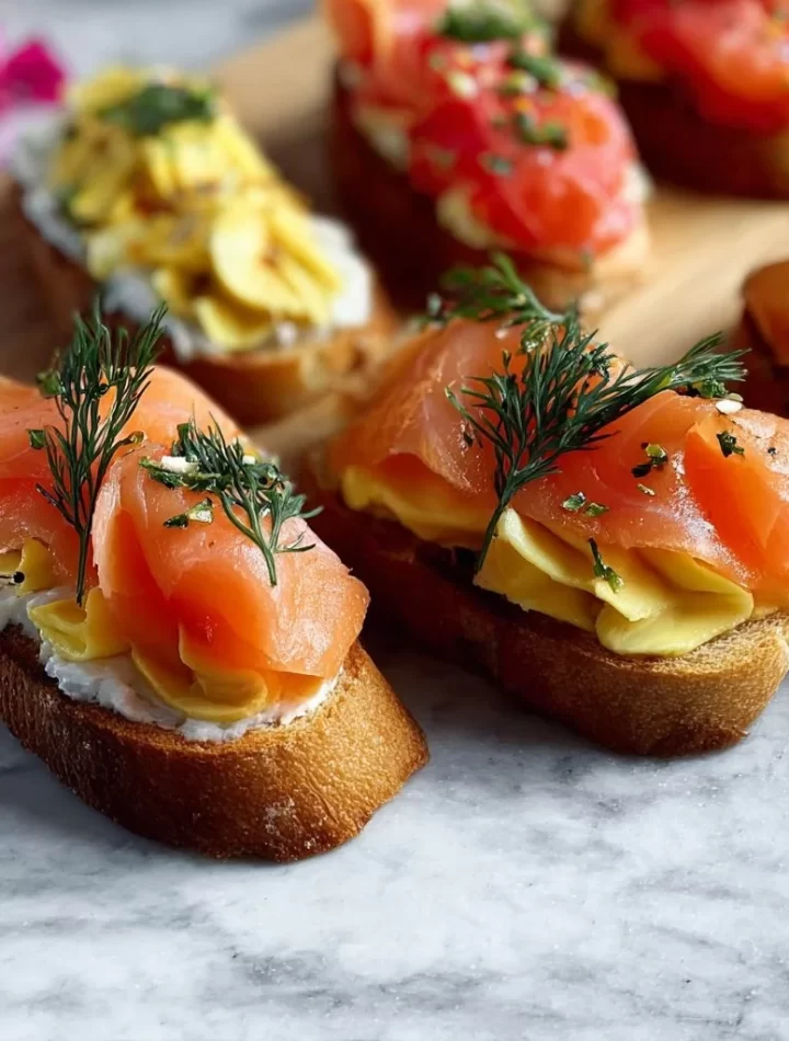 Delicious smoked salmon crostini topped with herbs on a platter