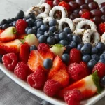 Colorful 4th of July fruit platter with red, white, and blue fruits.