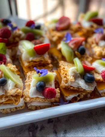 Variety of beach snacks including fruits, chips, and sandwiches for a sunny day.
