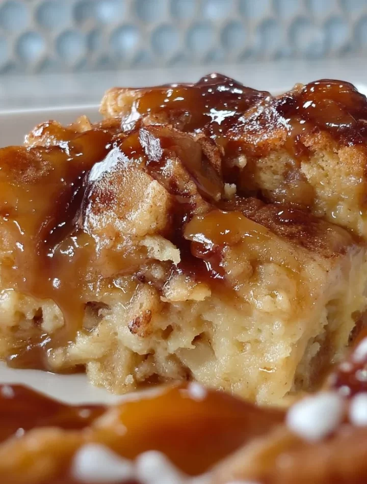Delicious caramel bread pudding topped with caramel sauce and whipped cream.