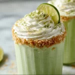 Creamy Coconut Key Lime Pie Smoothie topped with lime zest and coconut flakes
