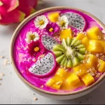 Dragon Fruit and Mango Smoothie Bowl topped with fresh fruits and seeds