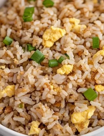 Healthy Blackstone Hibachi Rice served in a bowl with vegetables and garnishes.