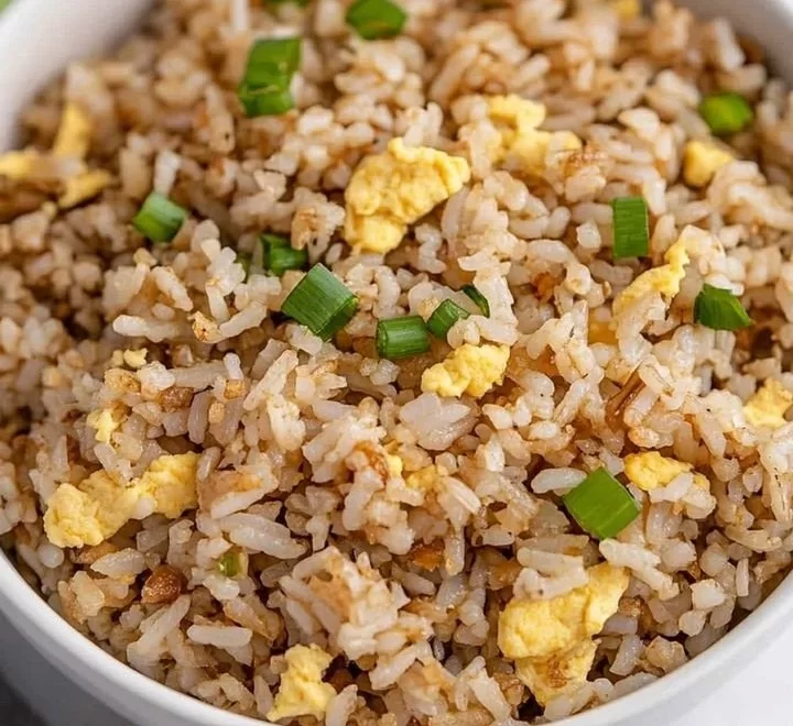 Healthy Blackstone Hibachi Rice served in a bowl with vegetables and garnishes.