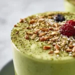 Healthy green smoothie with spinach, banana, and chia seeds in a glass