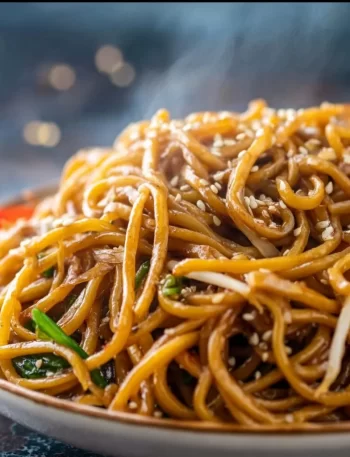 Delicious homemade Hibachi Noodles served in a bowl with vegetables and sauce.