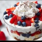 Easy 4th of July trifle dessert with layers of fresh berries and whipped cream