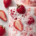 Homemade Korean Strawberry Milk in a glass with fresh strawberries.