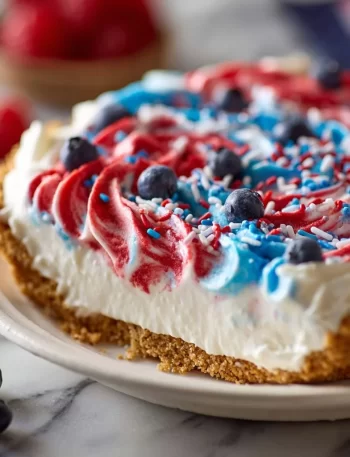 No-bake 4th of July swirl pie with vibrant red, white, and blue layers