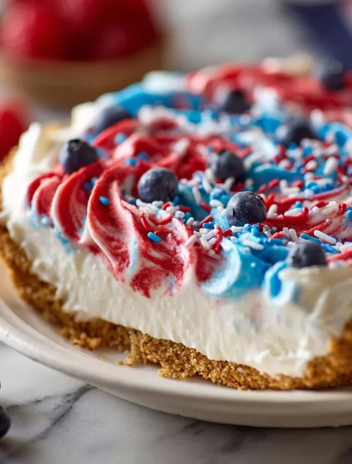 No-bake 4th of July swirl pie with vibrant red, white, and blue layers