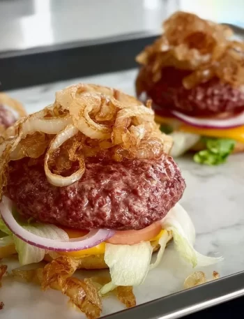 Oklahoma onion burgers topped with caramelized onions and served on fresh buns.