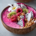Pink Pitaya Coconut Smoothie Bowl topped with fresh fruits and coconut flakes
