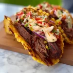 Delicious smoked BBQ beef tacos served with fresh toppings and sauces