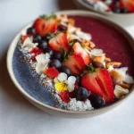 Colorful smoothie bowls topped with fresh fruits and granola for summer