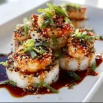 Spicy shrimp sushi stacks with vibrant ingredients on a plate