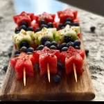 Colorful star-spangled fruit skewers with strawberries, blueberries, and bananas
