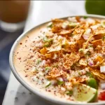 Bottle of southwest dressing on a wooden table with fresh vegetables