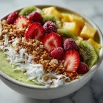 Delicious tropical smoothie bowl topped with fresh fruits and nuts